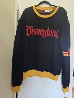 Disneyland black sweater with yellow and red trim and a retro collegiate logo